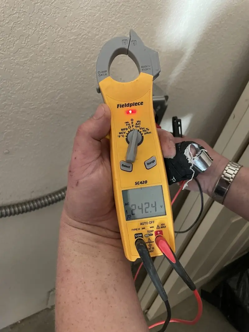 Voltage testing with clamp meter during Electrical Installation Services in On Top of the World